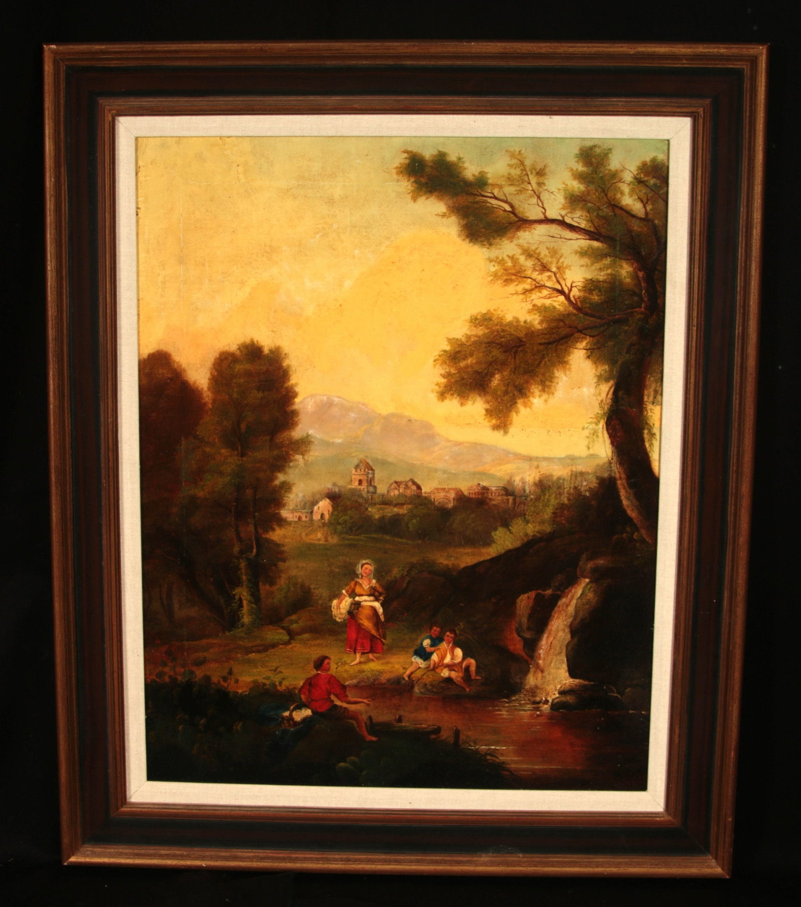 18th Century Italianate landscape oil painting: An antique Arcadian or Italianate landscape oil painting. The painting depicts an idealized classical landscape with a waterfall, a distant hilltop village, and rustic figures (staffage) interacting n