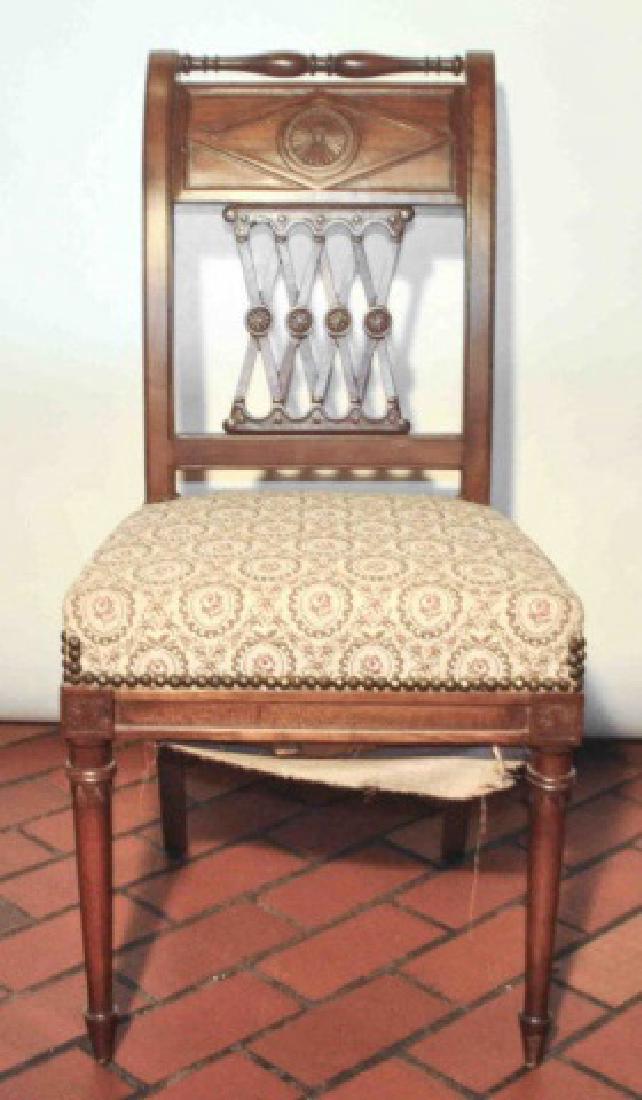 19th Century .Antique French Empire Side Chair: Charming French empire style side chair featuring an ornately carved wood back with a delicate medallion design. The floral upholstered seat is secured with wonderful vintage furniture nails. This is 