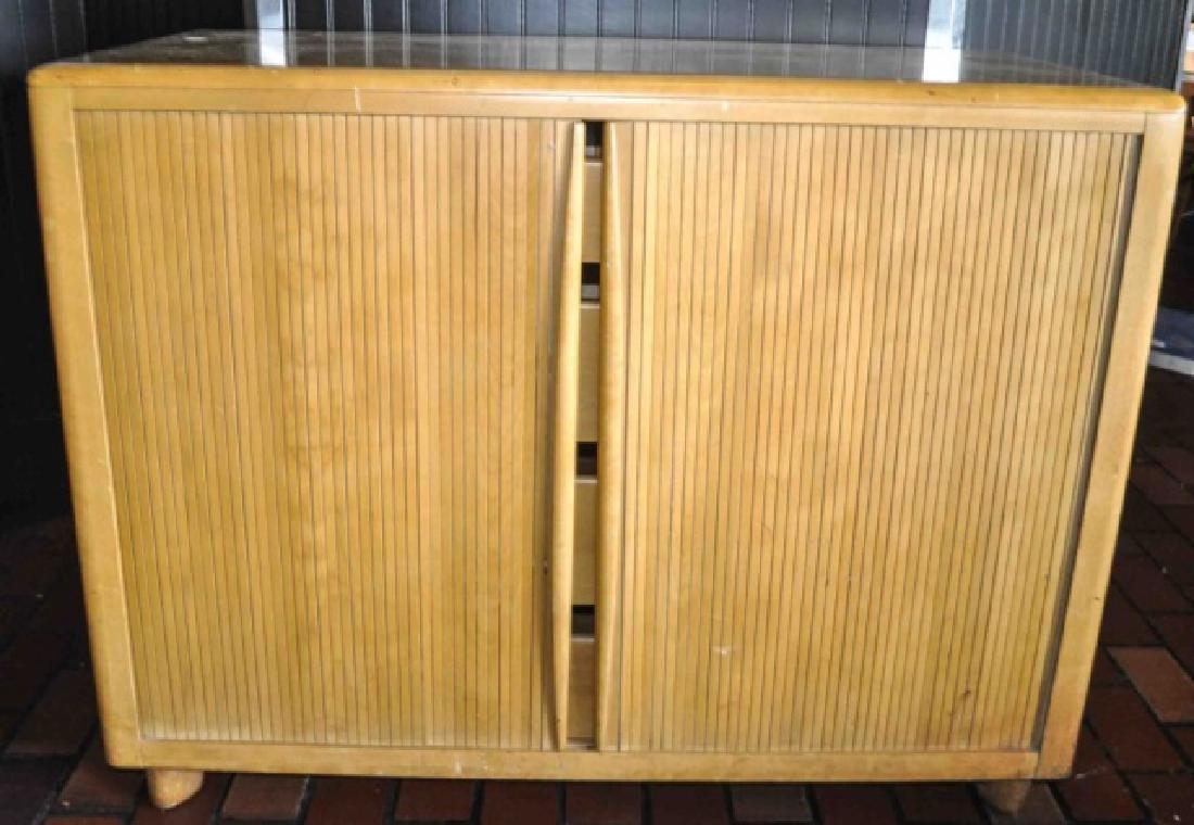 MCM Heywood Wakefield Tambour Storage Cabinet: Heywood Wakefield specializes in Mid Century Modern appeal furniture. Wood is harvested from Northern Yellow Birch trees on sustainable tree farms. The Tambour Cabinet features narrow, curved, wood sl