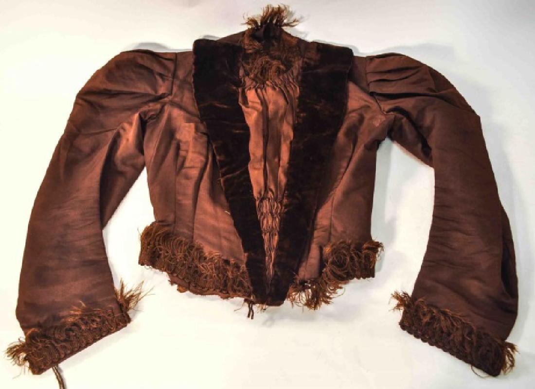 Antique Victorian Women`s Corset Styled Jacket: Antique Victorian women's brown corset style jacket with velvet on the breast and fringed collar and sleeves. Boning on the inside of the jacket. Nice quality and remains in nice condition. Smaller si