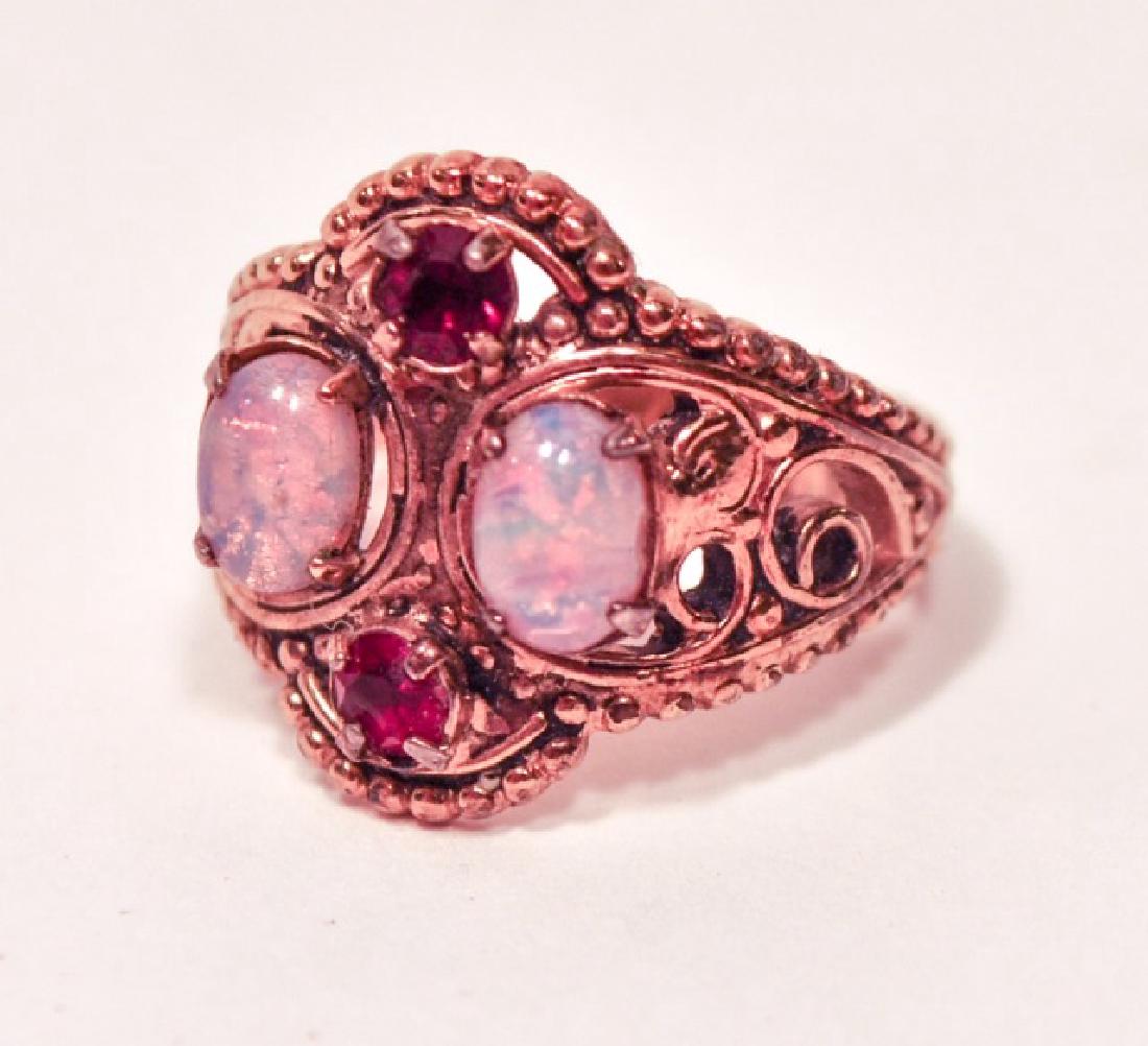Victorian Style Opal & Garnet Women's Ring: Antique Victorian styled women's ring featuring two large oval Opals, and two round red garnet stones. Approx size 5.