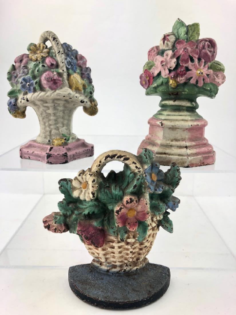 Lot of 3 Vintage Cast Iron Floral Basket Doorstops: Lot of 3 Vintage Cast Iron Floral Basket Doorstops. All doorstops in excellent condition. Original colors are still very vibrant for age. From the Estate of Everson Museum Director Sandra Trop. Measur