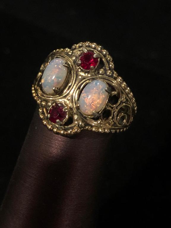 Victorian Style Opal & Garnet Women's Ring: Antique Victorian styled women's ring featuring two large oval Opals, and two round red garnet stones. Approx size 4.