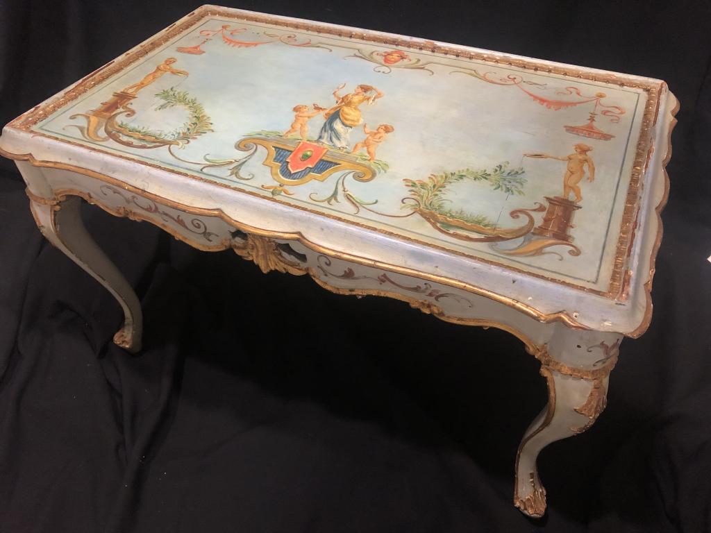 Majestic Handpainted French Accent Coffee Table: A stately, majestic piece of art describes this Handpainted French accent coffee table. The sky blue background to the serene colors of woman with children to the beautiful gold gilt borders. A true m