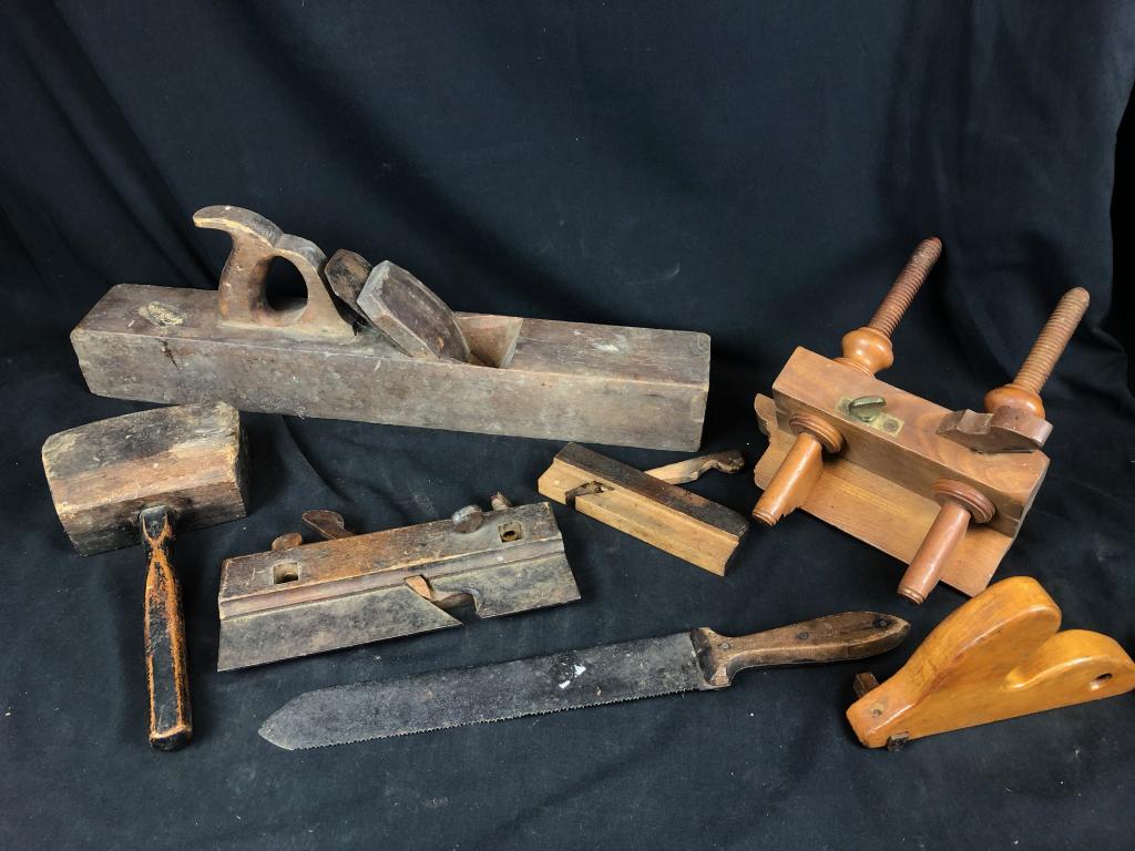 Lot of Primitive Woodworking Tools: Includes: Wooden Screw Arm Plough Plane, Large Wooden 21-1/2" Planer, Wooden Mallet, Serrated Antique Saw with Wooden handle and much more!