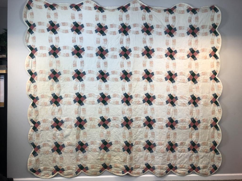 Handmade Double Wedding Ring Quilt Florals/Solids: Handmade Antique Double Wedding Ring Quilt Florals & Solids for patterns. Colors Forest Green, Mauve, Wedgewood blues. Cream background and back. Scalloped Edge. Small area of Edge Binding Separation.