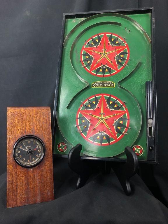 Lot of Vintage Aircraft 8 DayClock & Pinball Game: This lot includes two items: 1). Vintage Aircraft 8 Day Clock in a custom holder. 7-1/4" x 3-1/2" 2). Lindstrom's Gold Star Vintage Pinball Game. 15-1/2" x 9-1/2" Two items that would be wonderful in