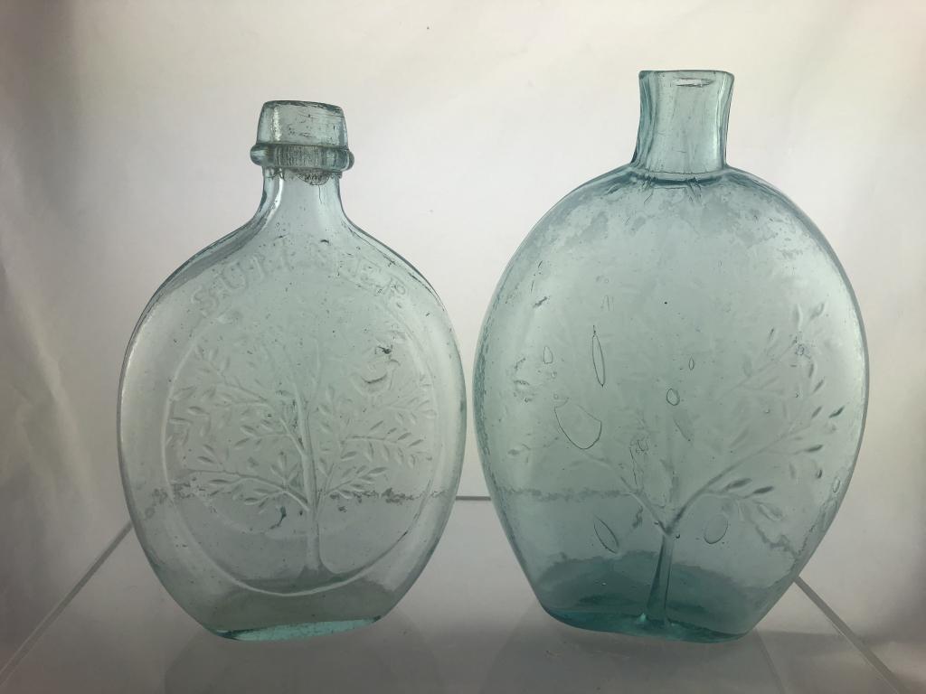 2 Tree Foliage Historic Flasks GX-15, GX-18: Two Tree Foliage Historic Flasks including 1) GX-15 Pint, Aqua Green with tiny bubbles, Oval Panels Large Tree in foliage with bird perched on branch at right "Summer" / Large 