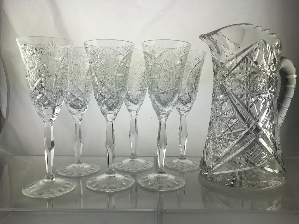 Set of 6 ABP Cut Crystal Wine Flutes & Pitcher: Set of six clear APB" American Brilliant Period" crystal Wine glass flutes with etched and cut star patterns, measures 8" tall. Includes ABP cut crystal pitcher with saw tooth edge measuring 8-3/4" ta