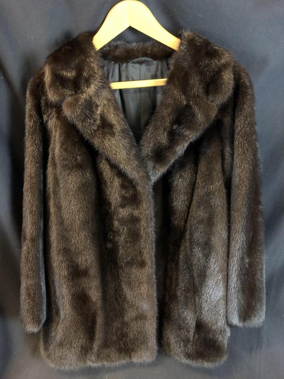 Dark Saga Mink Fur Coat: Glossy dark Saga mink fur coat with embroidered lining. From "Stoll Hanover". Measures: 19" shoulder, 21-1/2" sleeve, 27" collar to hem.
