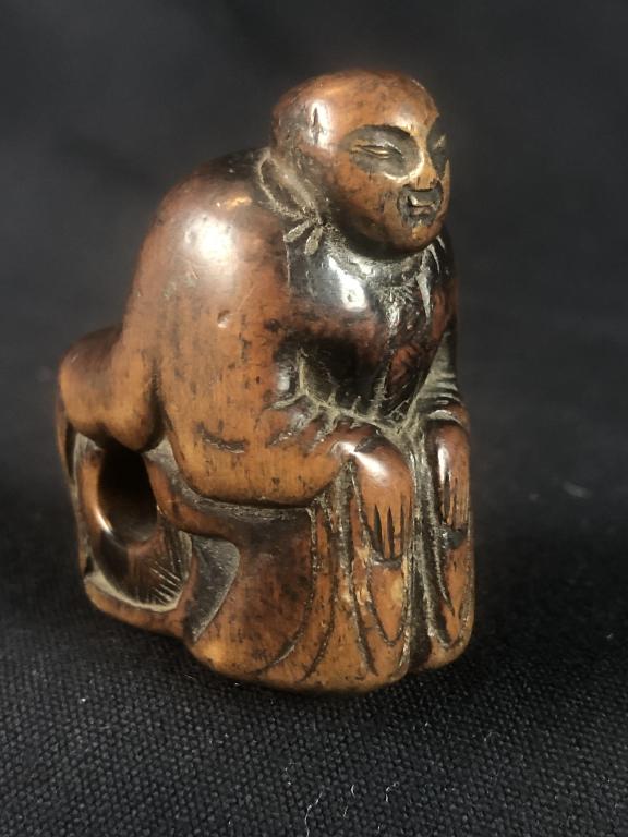 Seated Figural Unusual Netsuke Japanese BoxWood: Unusual hand-carved Boxwood seated figure with 4 hole cube shaped himotoshi. Measures: 2" x 1-1/5". (Signed?)
