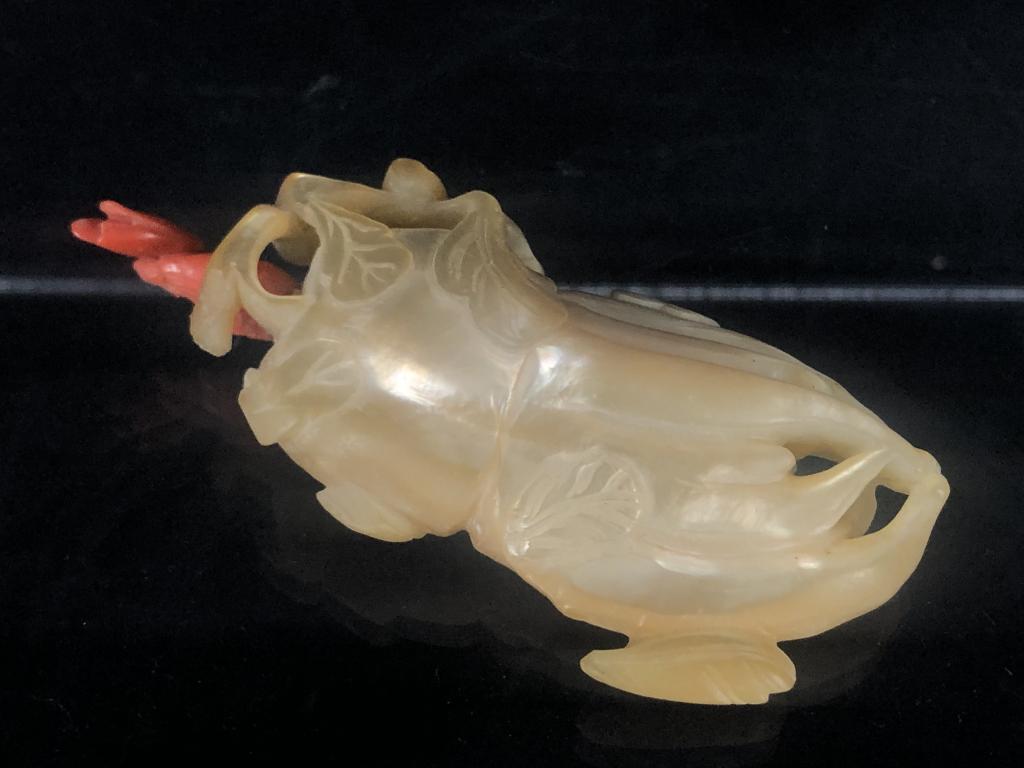 Rare Mother of Pearl Buddha's Hand Snuff Bottle: Exquisite carved mother of pearl and coral snuff bottle in the form of a Buddha's hand / finger citron with leaves. A stunning piece with gorgeous luster and detailed form. Measures: 3-1/4" x 1-1/2".