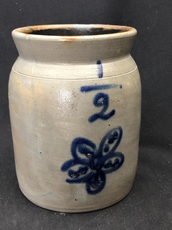 1/2 Gal Stoneware Crock w. Lg.Deep Cobalt Flower: 1/2 Gallon cylindrical salt glazed stoneware crock with tooled shoulder and flared, semi-round rim. Cobalt blue large 1/2 capacity mark and underneath a five petal flower with three dots in each petal