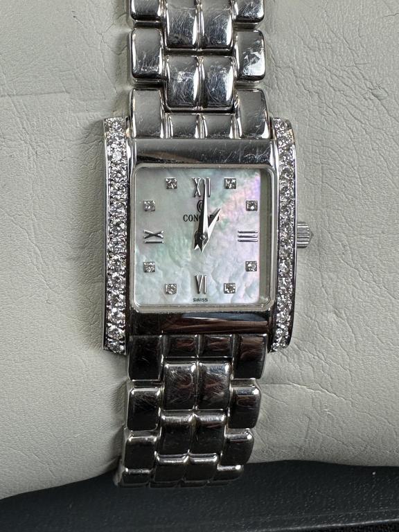 Concord La Tour Watch 14K White Gold Diamonds MOP: Ladies' Concord La Tour watch in 14 karat white gold case and bracelet. Synthetic sapphire crystal. 20 x 25mm case. Case set with 28 stones. Mother of pearl dial set with 8 diamonds. Diamonds set crow