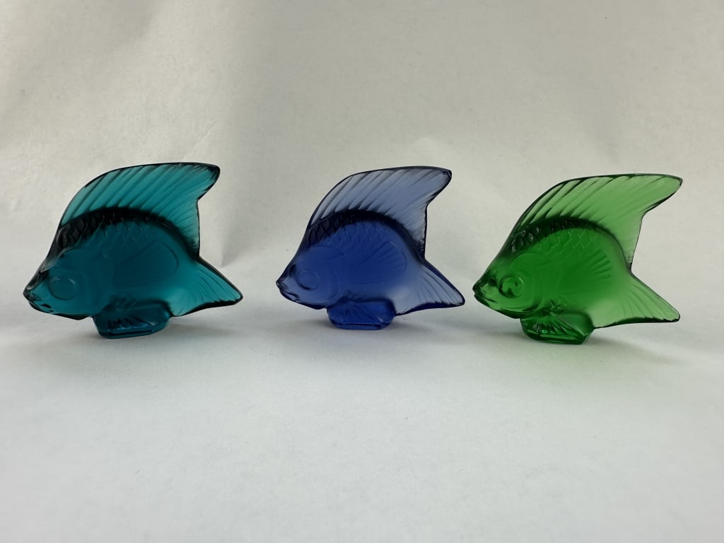 3 Lalique Cut Crystal Iconic Fish BeachGlass Tones: 3 Lalique Cut Crystal Iconic Fish BeachGlass Tones Set of three iconic crystal Lalique fish in cool Beach glass tones of ocean blue, teal, and grass green. Measures: 2" x 2".