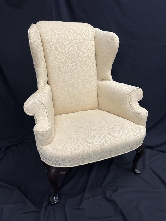 Antique Queen Anne Upholstered Wingback Chair: Antique Queen Anne Upholstered Wingback Chair Antique Queen Anne period upholstered wingback chair in a yellow textured fabric with queen anne wooden legs. Measures: 43" h, 16" seat x 34" w x 23" d.