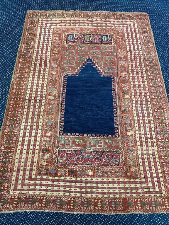 Intricate 18thC. Turkish Ghirodes Prayer Rug: Intricate 18thC. Turkish Ghirodes Prayer Rug Rare 18th century Oriental Turkish Ghirodes prayer rug with green silk selvedge and deep navy center. Nice thick pile for age, some areas with black dye ar