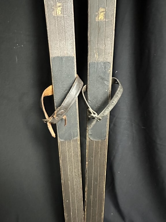Pair of Antique Wood Skis w/ Leather Bindings: Pair of Antique Wood Skis w/ Leather Bindings Antique downhill skis with leather and metal binding. Likely hickory wood, these skis have a beautiful patina and bindings that indicate late 19th or earl