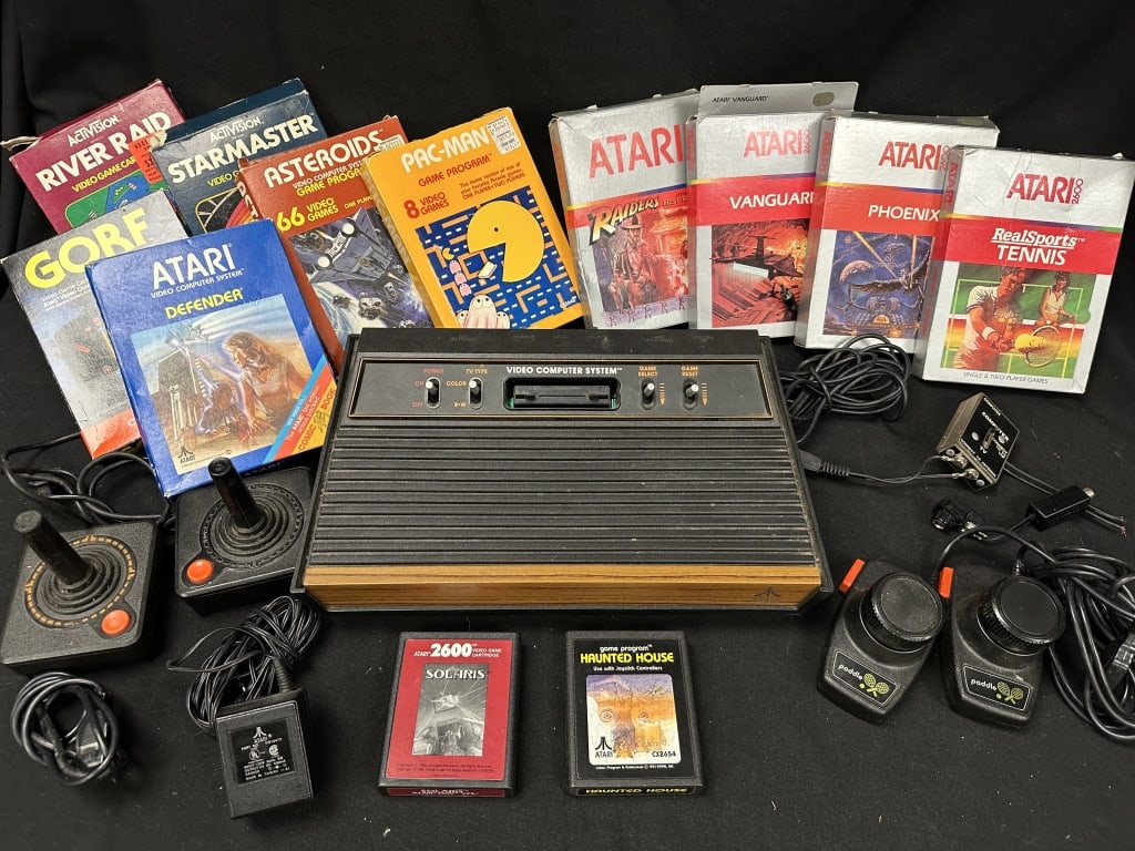 Atari CX-2600 VCS Game Station w/12 Games + attch.: Original Atari Video Computer System game system. Serial number 81124406. With controller attachments, paddle attachments, and cables. Includes games in original Box: Pac-man; River Raid; Starmaster; 