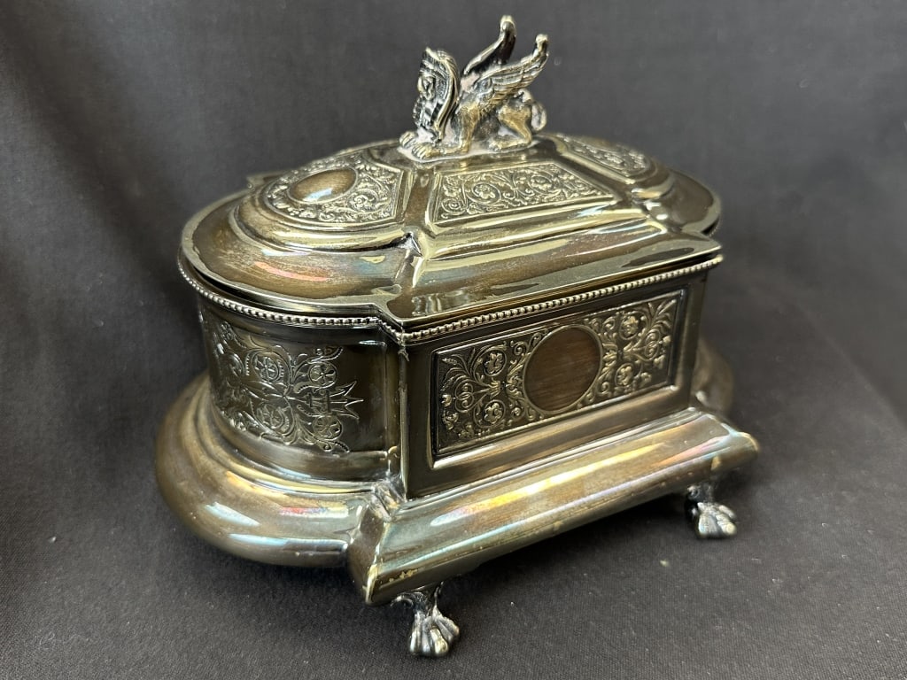 Victorian Silver Winged Griffin Trinket Box: An antique Victorian silver trinket box with ornate scrollwork patterns, featuring claw feet and a figural winged griffin finial on the lid. This 19th century piece was made in England by Henry Wilkin
