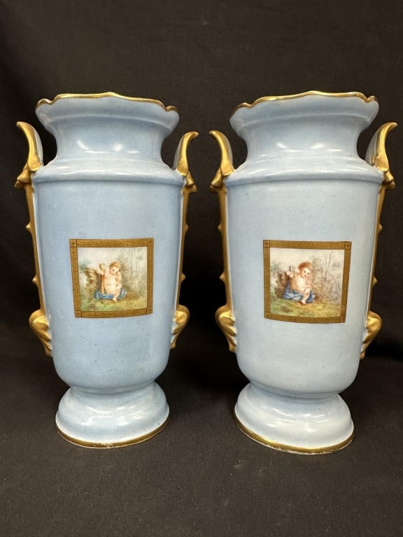 Pr. of French Porcelain Vases w/Handpainted Scenes: An antique pair of French Victorian porcelain vases, featuring a lovely light blue color with gold accents, including a pattern framing the hand-painted putti scenes. Measures: 6" W x 10-1/4" H x 4-3/