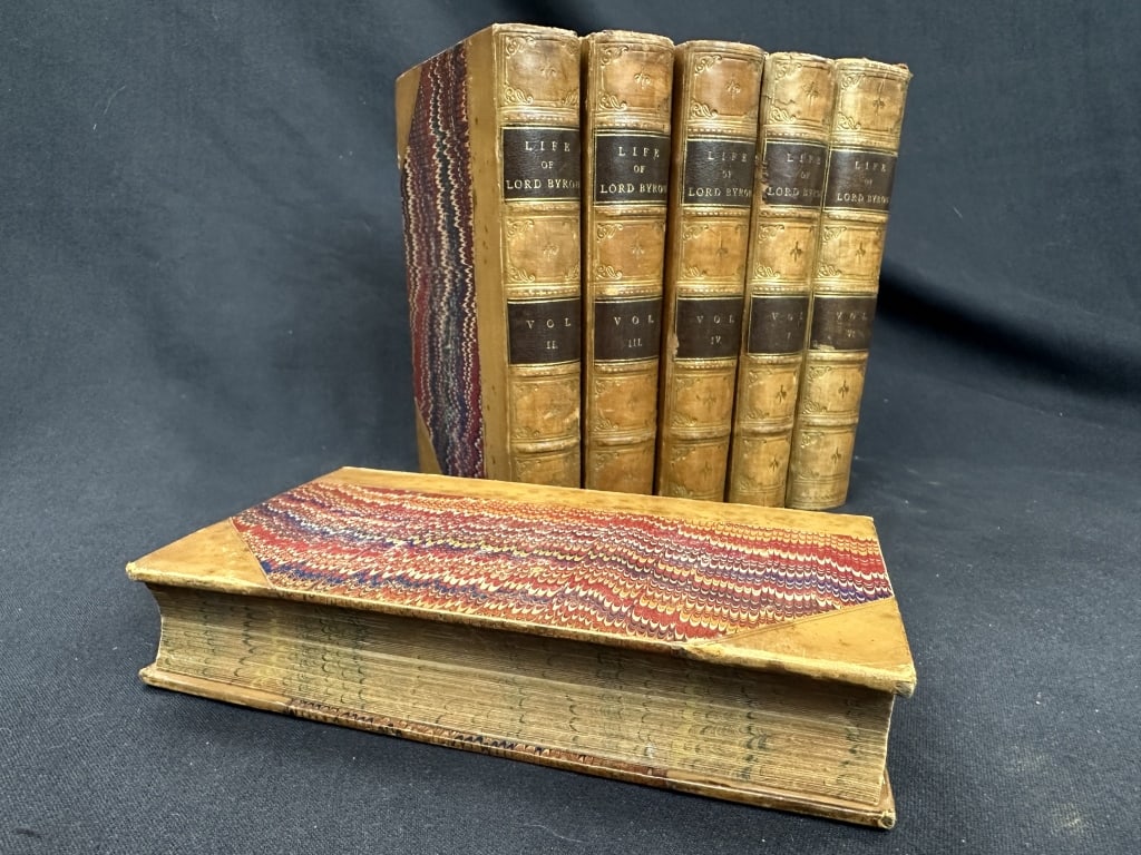 "Life of Lord Byron" Antique 6-volume Book Set: An antique 6-volume collection of books titled "Life of Lord Byron" by Thomas Moore. The cover of each book features a decorative spine that displays the title and volume number. A colorful marbelized