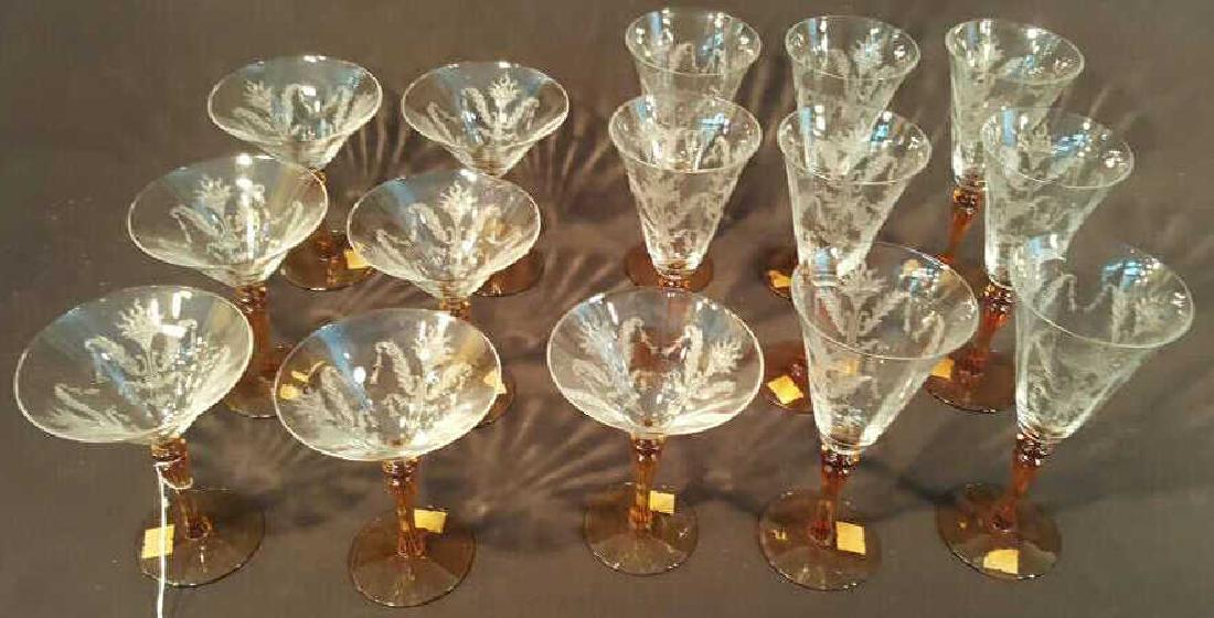 Lot of 15 Tiffin Glass Stemware Pieces: Lot of 15 Tiffin Glass Stemware Pieces, Julia pattern, including 7 champagnes and 8 wine glasses. Feature amber colored stems and etched glass bowls.