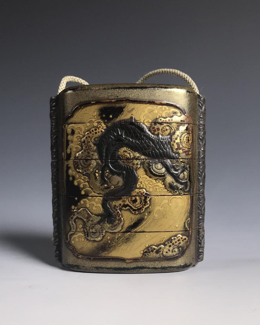 JAPANESE INRO WITH DRAGON AND NETSUKE DOG: JAPANESE INRO WITH DRAGON AND NETSUKE DOG, segmented box joined together with an obi. Dimension: 6cm ( 2 3/8 in) PROVENANCE: Property of a prominent collector from Northumberland, Pennsylvania.