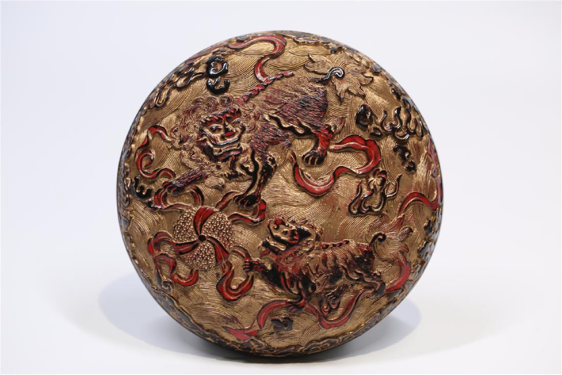 Lacquered Circular Covered Wood Box With Mark: Lacquered Circular Covered Carved Wood Box With Mark, cover carved with a mythical beasts and bottom with a floral pattern ,with lacquered interior and mark Dimension: 18.5cm dia. A LIST OF RECOMMENDE