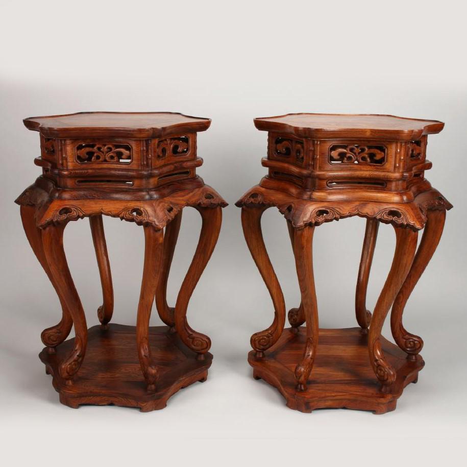 PAIR OF HUANGHUALI HEXAGONAL VASE STANDS: PAIR OF HUANGHUALI HEXAGONAL VASE STANDS, sit on six curved cabriole legs that terminate into hoofs, with carved and pierced aprons and carved and scalloped panels that alternate with vertical bamboo 