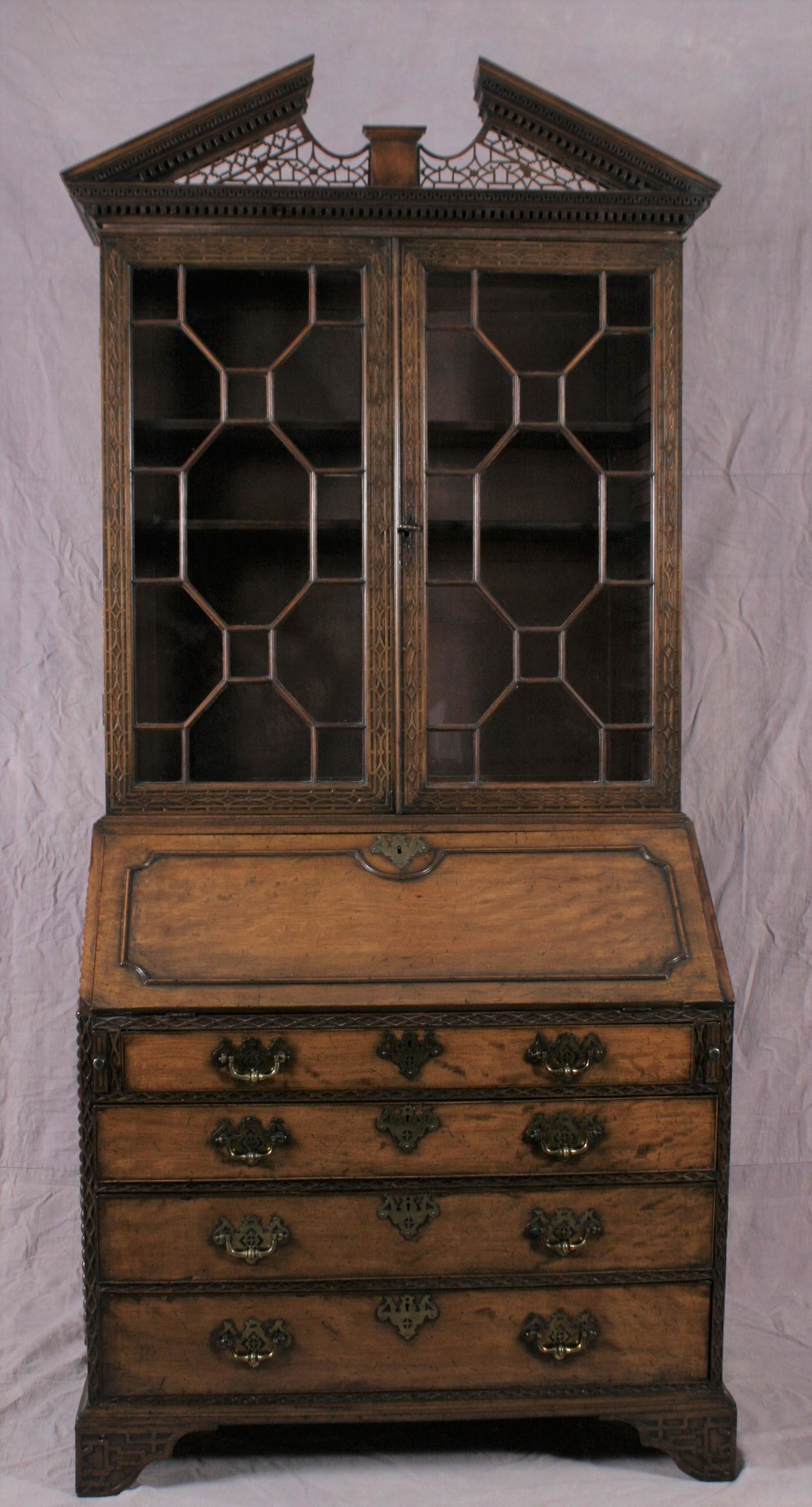 Fine and Rare English George III Walnut Secretary: A fine and rare English George III (c. late 18th century) walnut secretary/bookcase A pair of mullion glazed doors, with a lower section fall-front and fitted interior, all above four elegantly gradua