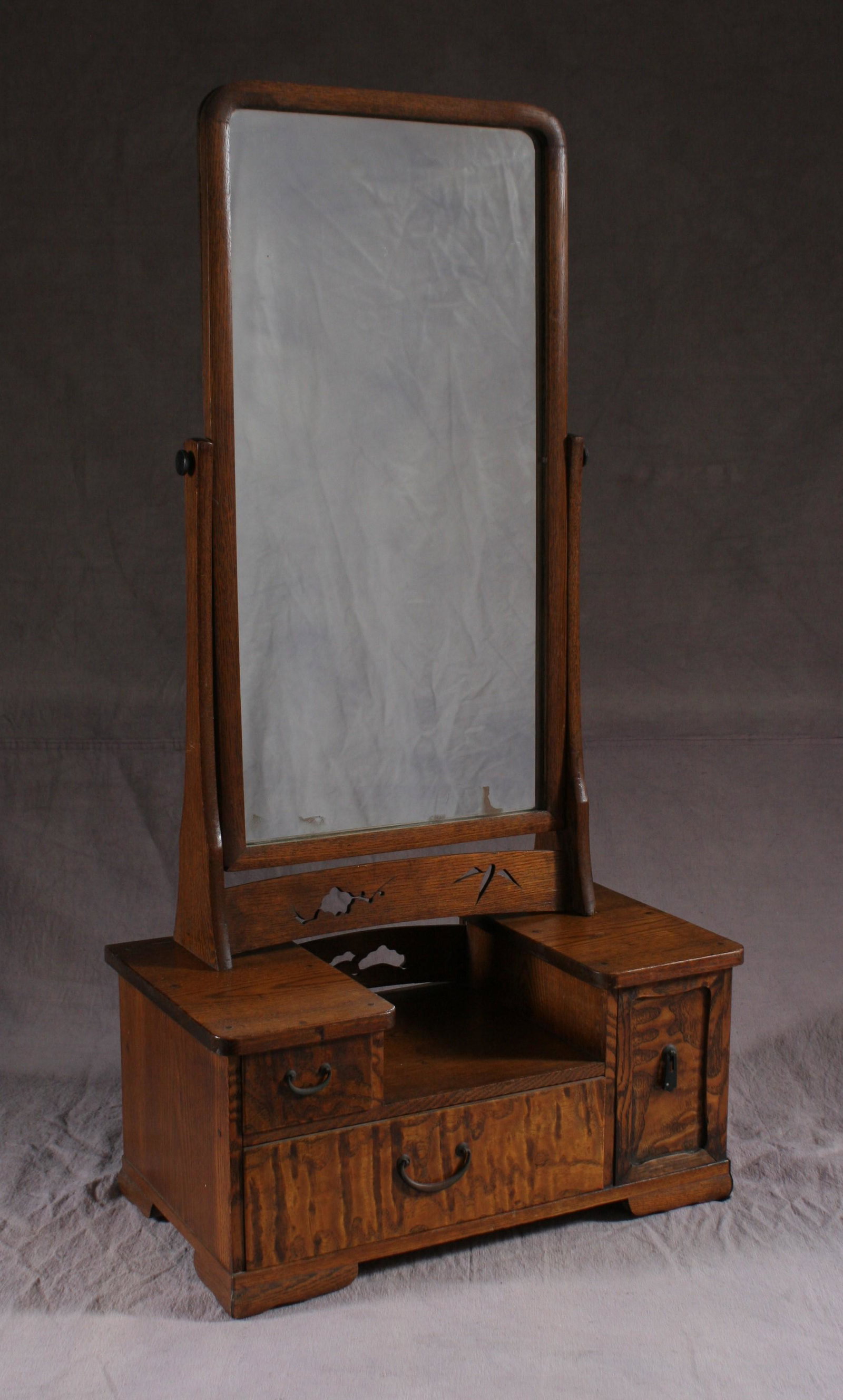 A charming portable provincial Japanese vanity with: Lovely wavy grained wood with pierced carving and metal fittings. c. 100 years old Dimension: 31" high x 14" wide x 8 3/4" deep. A LIST OF RECOMMENDED THIRD-PARTY SHIPPER IS AVAILABLE UNDER SHIPPING I