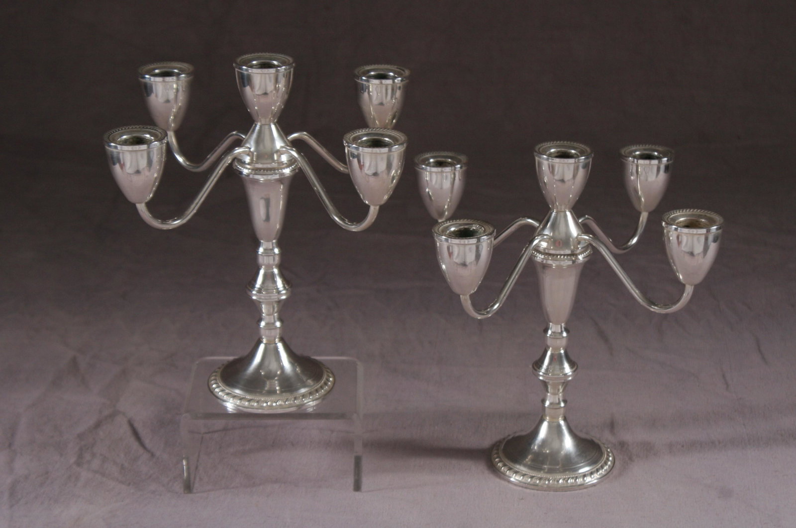 Pair of American weighted sterling candelabras: Pair of American weighted sterling five-light candelabras, signed Duchin An excellent pair of American weighted sterling five-light candelabras. Signed Duchin creation and other marks. Each foot and c