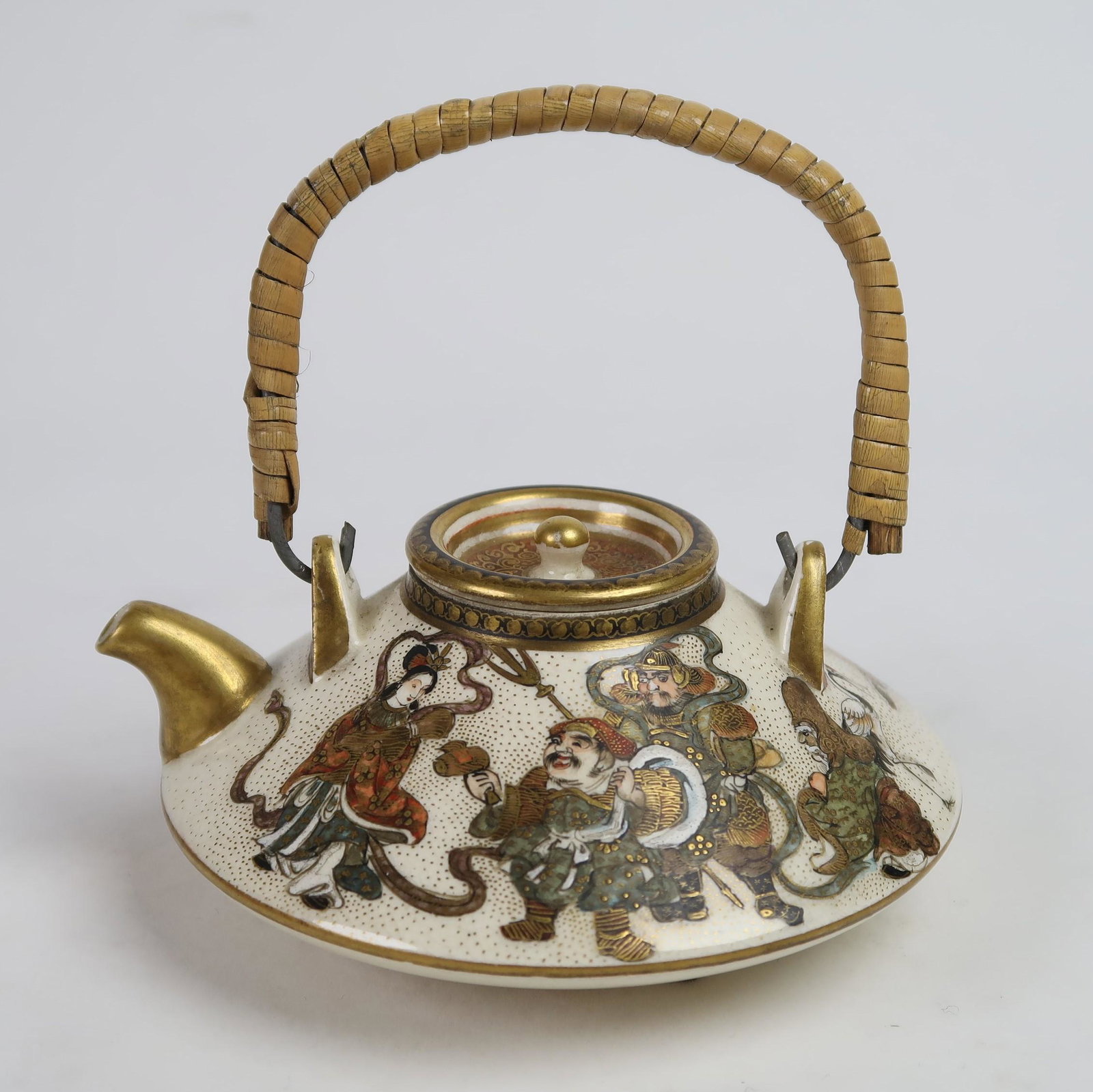 Japanese Meiji period Satsuma teapot decorated in: A delightful and well-drawn Japanese satsuma teapot decorated in enamels and gilt, depicting the Shichi Fuku Jin (Seven Gods of Good Fortune) around the body. Signed. Ex Kohut Collection #1114. Meiji 
