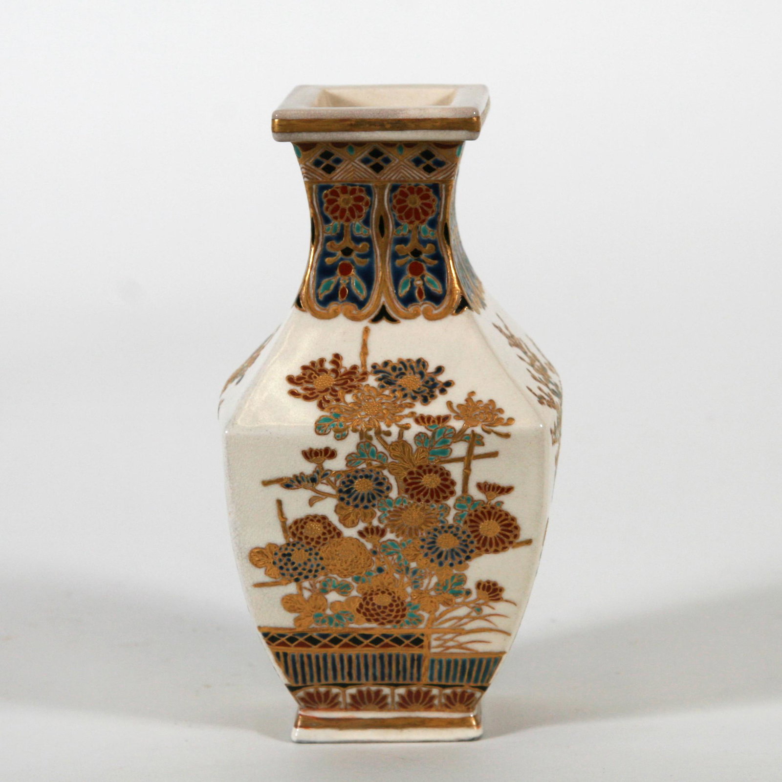 Classic Imperial Satsuma Vessel, Meiji Period: Classic Imperial Satsuma vessel, Meiji period. Fine floral motif on faceted body in Gossu blue, gold and other enamels. Signed in gold with blue Satsuma crest of the Lord of Shimazu. Dimension: 7" H. 