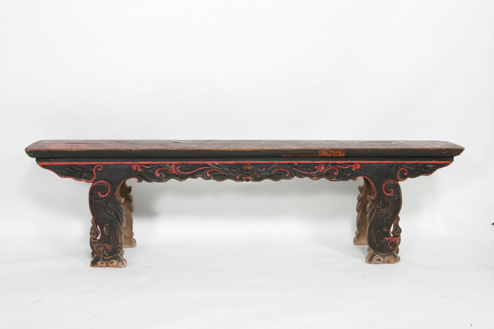 Carved Chinese Long Bench, 19th Century: Carved Chinese Long Bench, 19th Century. This very well carved long bench is from Southwest China near Burma. The top is an exceptional and massive single piece of wood. The fretwork and legs are also