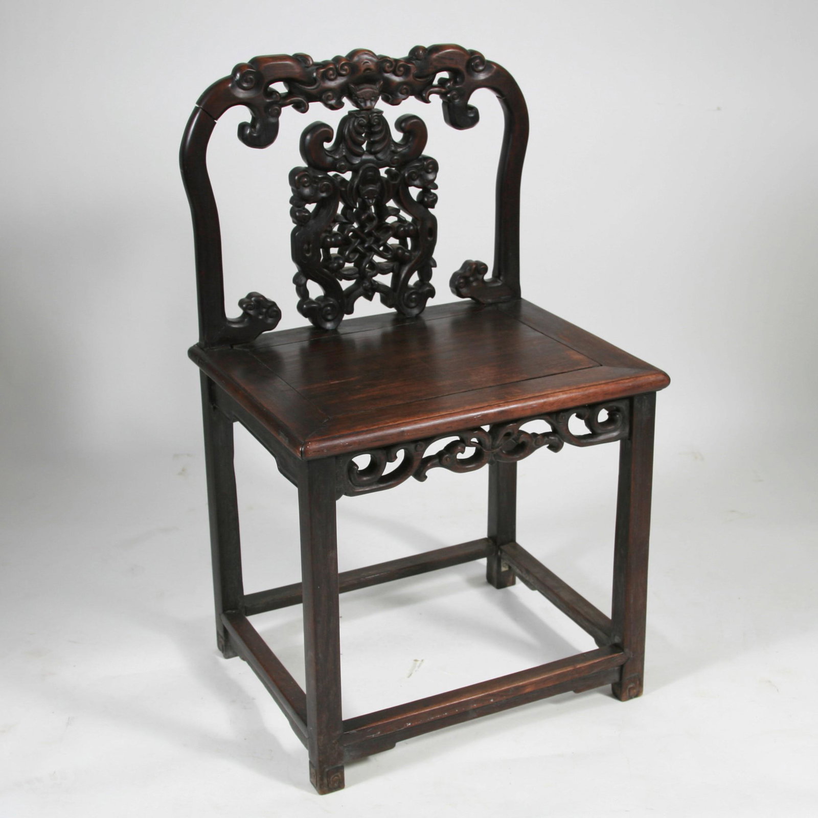 Chinese Hardwood Chair, 19th Century: Chinese Hardwood Chair, 19th Century. A finely carved Tao Kuang (1821-1850) side chair with bats, herb of immortality and openwork fretwork. Dimension: 35 1/2" high x 21" wide x 16 3/4" deep. A LIST O