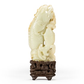 A CARVED WHITE JADE FISH-DRAGON