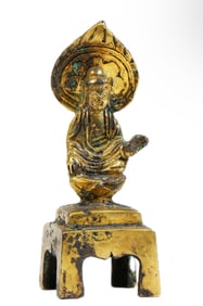 A BRONZE-GILT SEATED BUDDHA