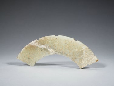 A CARVED JADE ARCHED PENDANT HUANG