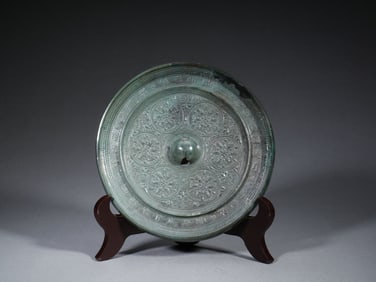 A BRONZE CIRCULAR MIRROR