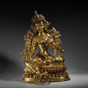 A BRONZE-GILT GREEN TARA
