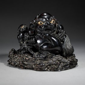 A CARVED ROSEWOOD MYTHICAL BEAST