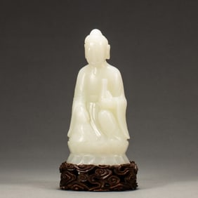 A CARVED WHITE JADE FIGURE