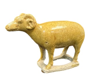 A GLAZED POTTERY FIGURE OF A RAM