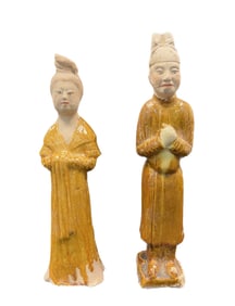 A GLAZED POTTERY FIGURE OF A MAN AND WOMEN