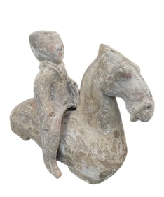 A POTTERY FIGURE ON HORSEBACK