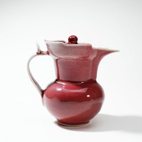 A RARE CHINESE RED GLAZE MONKS CAP EWER