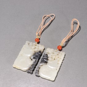 A PAIR OF CHINESE CARVED JADE PENDANTS