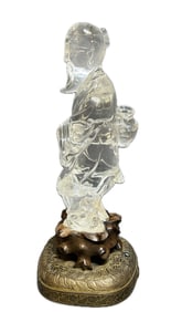 A CARVED CRYSTAL FIGURE WITH BASE